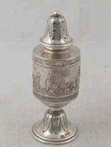 Appraisal: A hallmarked silver pepperette with embossed rural scenes import marks