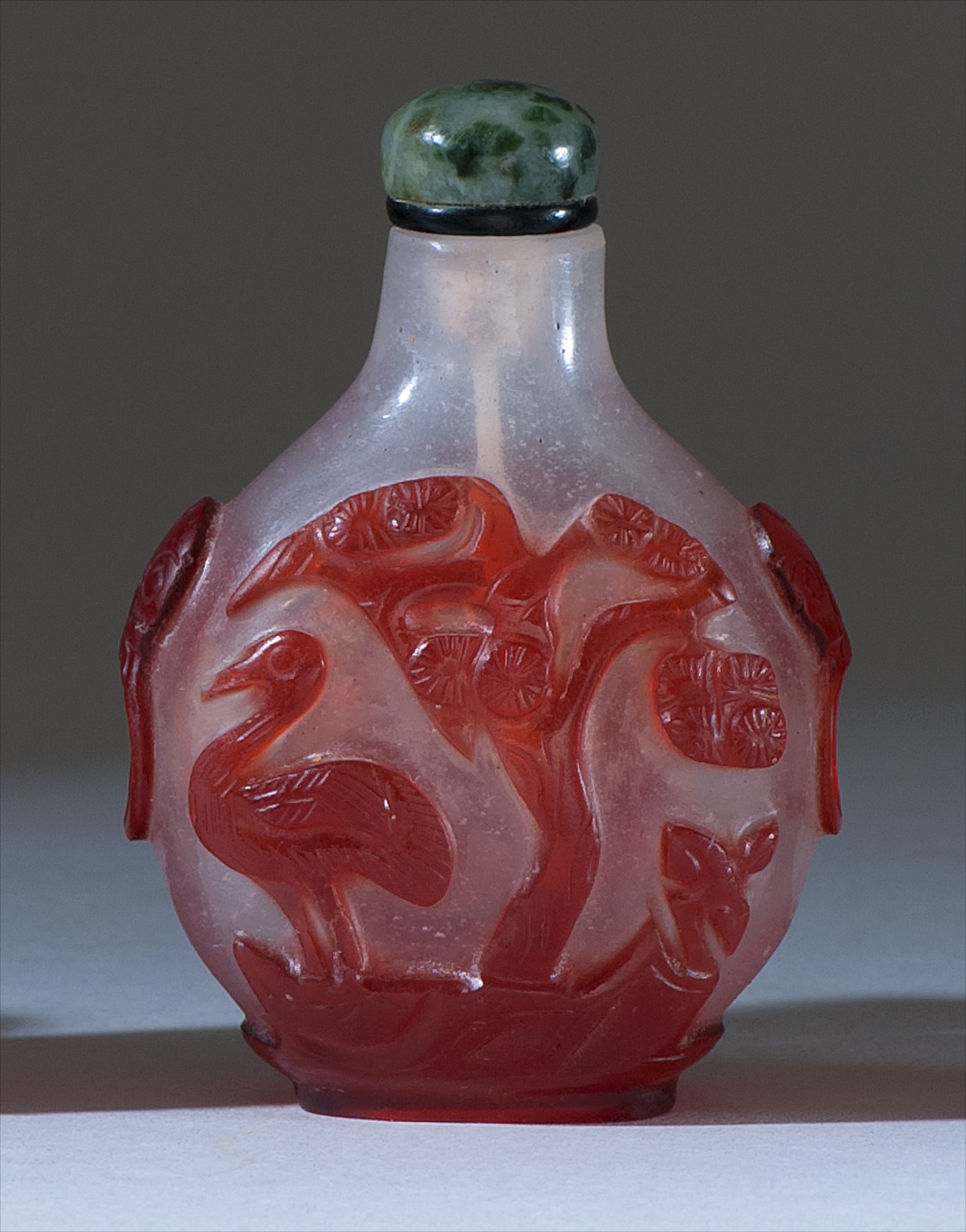 Appraisal: OVERLAY GLASS SNUFF BOTTLE th CenturyIn pear shape With mask