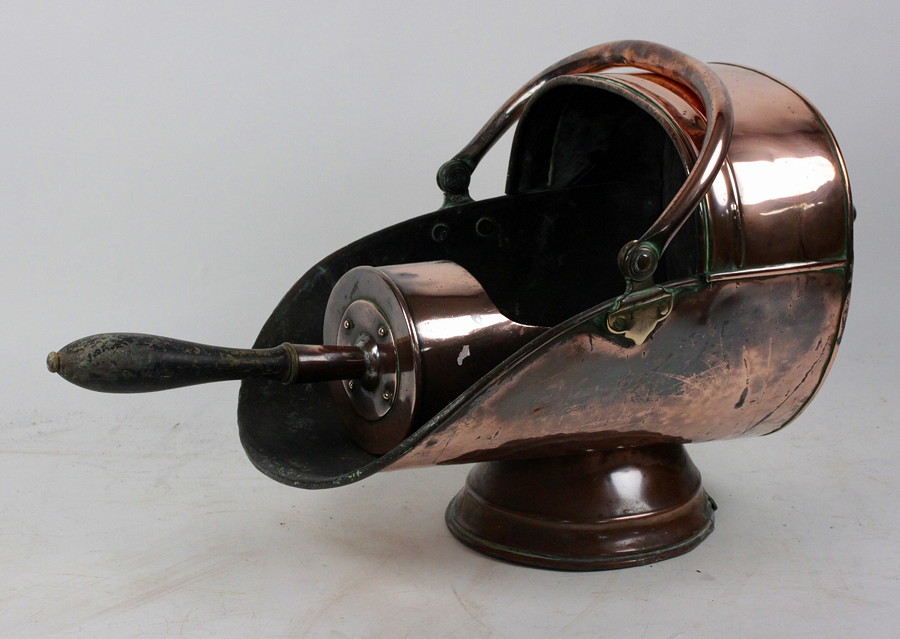 Appraisal: A copper coal scuttle with swing handle and scoop