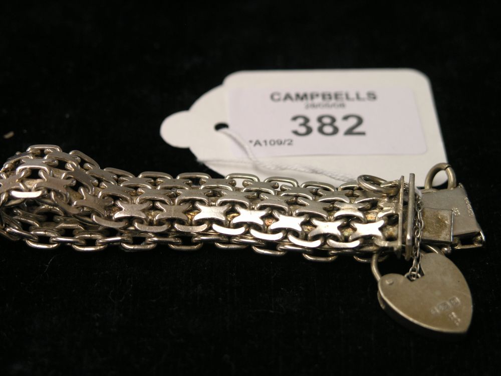 Appraisal: A silver bracelet with padlock clasp