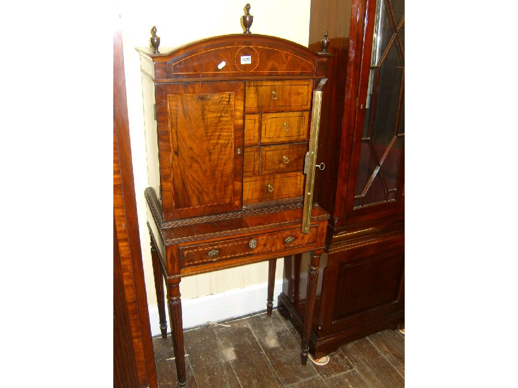 Appraisal: A Georgian oyster veneered cabinet on stand enclosed by two