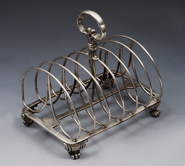 Appraisal: A VICTORIAN SILVER SIX DIVISIONAL WIREWORK TOAST RACK on four