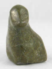 Appraisal: An Inuit carved greenstone study of a seated penguin signed