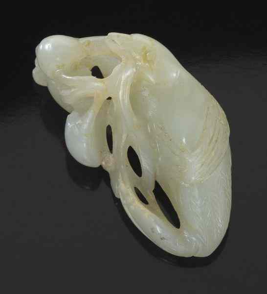 Appraisal: Chinese Qing carved white jade birdwith peaches in its mouth