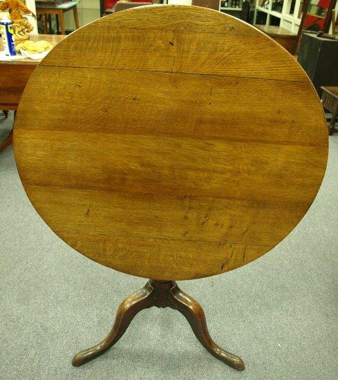 Appraisal: An early th Century oak tripod table the circular top