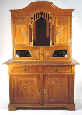 Appraisal: A large Belgian Art Nouveau oak sideboard with leaded glass