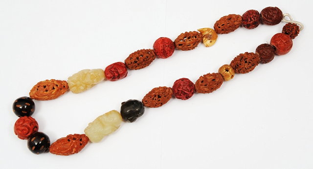 Appraisal: A CHINESE CARVED NUT AND JADE SET NECKLACE cm