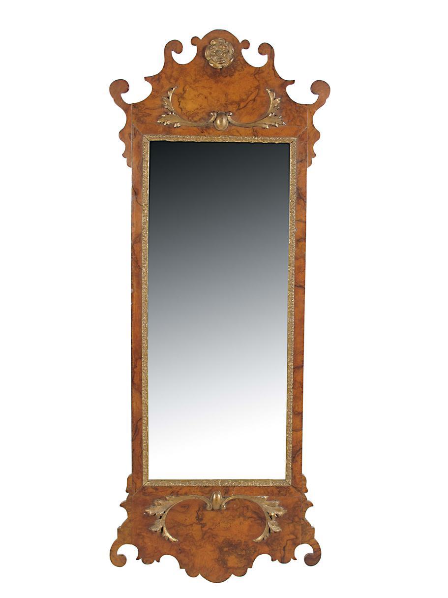 Appraisal: A walnut and parcel gilt fret-frame wall mirror in George