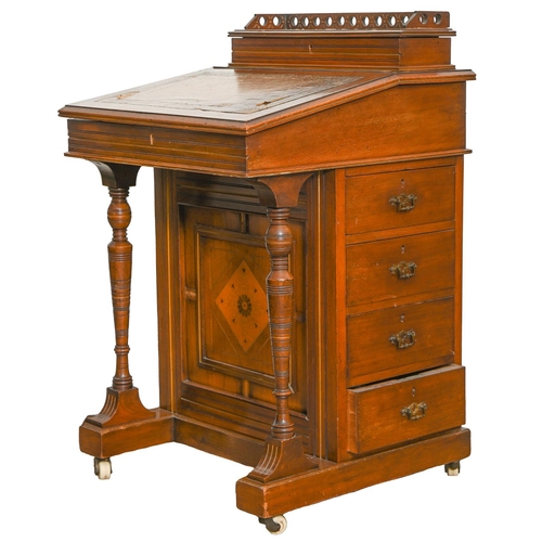 Appraisal: A Victorian walnut davenport with sycamore veneered fitted interior pierced