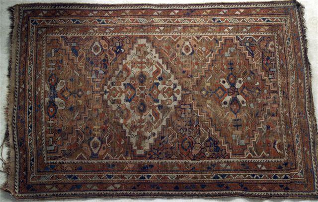 Appraisal: PERSIAN SHIRAZ RUG with a brown ground m by m