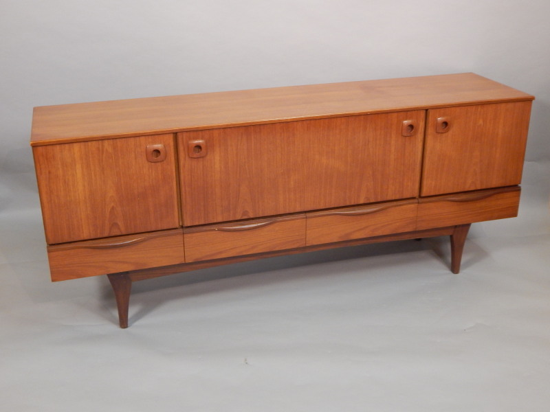 Appraisal: A retro style teak sideboard with two doors and fall