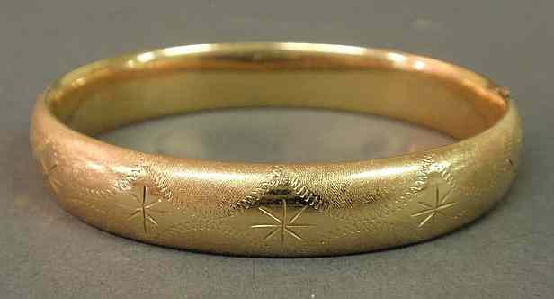 Appraisal: Gold bangle bracelet k hinged with an overall etched design