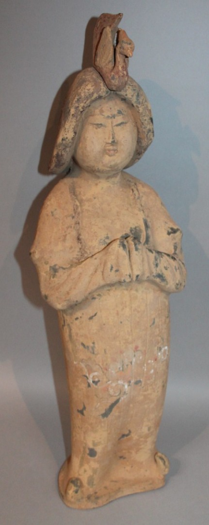 Appraisal: A Chinese terracotta finish figure of a standing lady in