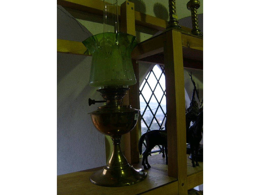 Appraisal: A brass based oil lamp with etched green tinted glass