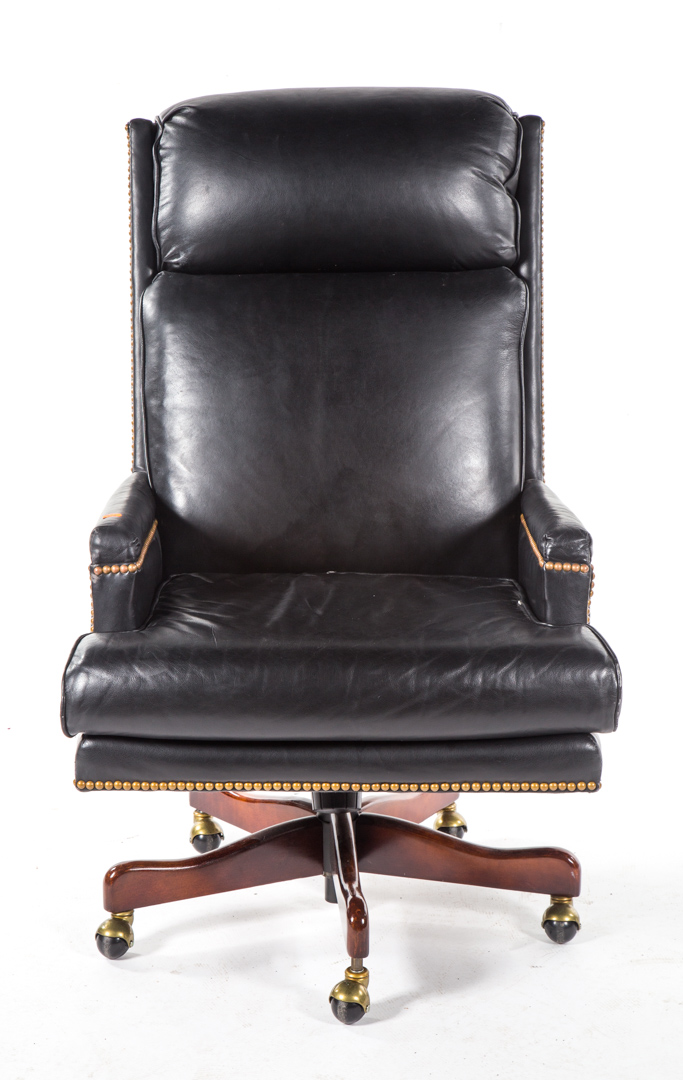 Appraisal: Contemporary upholstered executive swivel armchair brass tack upholstery wood base