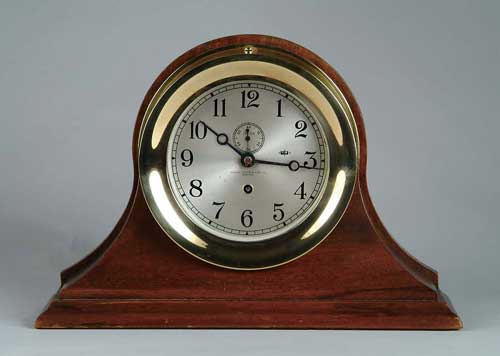 Appraisal: CHELSEA BRASS SHIP S CLOCK Housed in a mahogany stand