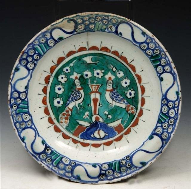 Appraisal: AN IZNIK POTTERY DISH decorated with two peacocks in a