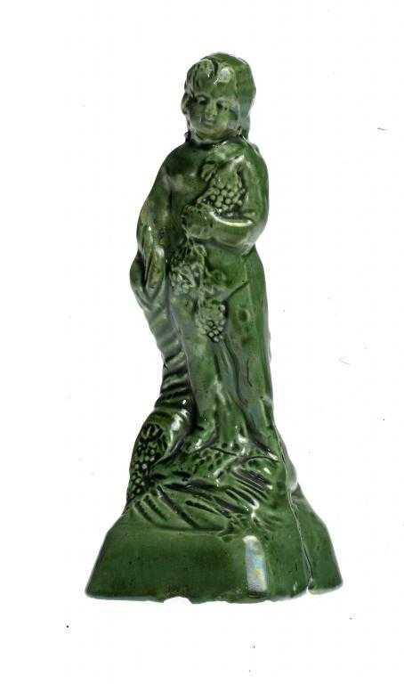 Appraisal: A STAFFORDSHIRE GREEN GLAZED EARTHENWARE FIGURE OF A CHILD emblematic