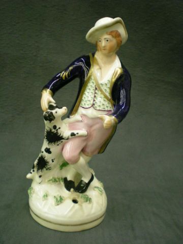 Appraisal: Staffordshire quill holder depicting a man and his dog nicely