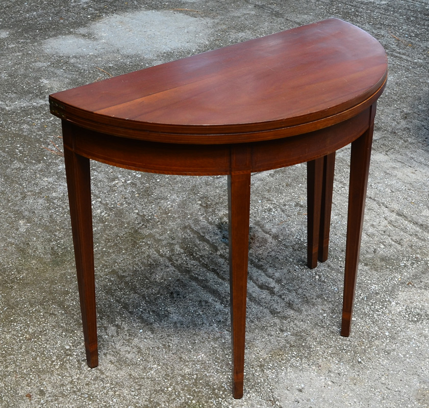 Appraisal: MAHOGANY DEMILUNE GAME TABLE Flip top with gate leg string