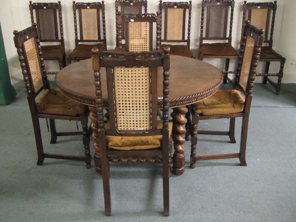 Appraisal: Carved oak circular dining table with ten oak and cane