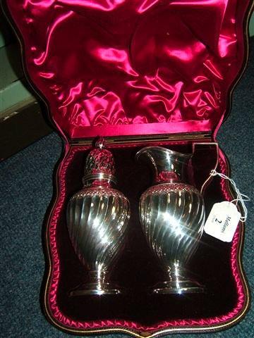 Appraisal: A Victorian silver cream jug and matching sugar sifter of