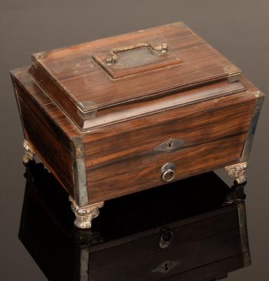 Appraisal: A Regency rosewood sewing box of sarcophagus-shape metal bound fitted