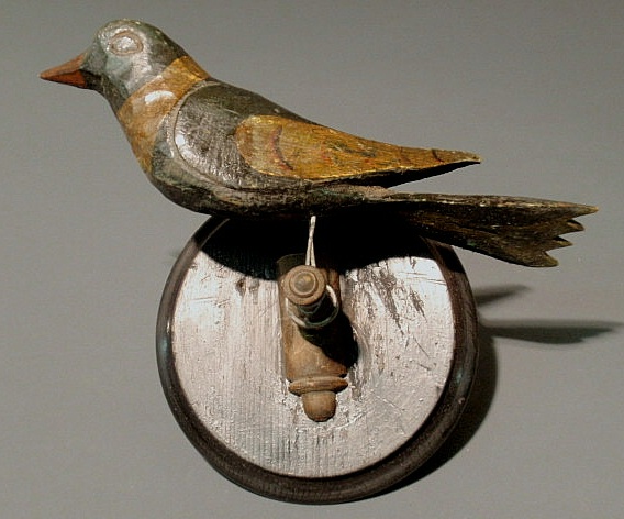 Appraisal: German folk art carved bird with a black circular stand