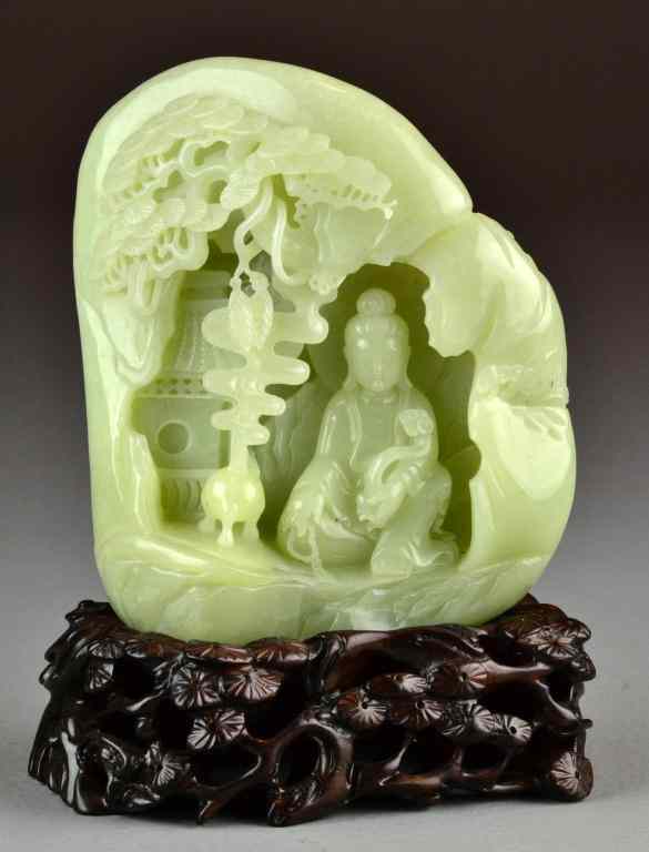 Appraisal: Chinese Carved Celedon Jade BoulderDepicting a seated Buddha with scepter