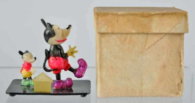 Appraisal: Celluloid Disney Walking Mickeys on Platform Toy Description Sticker on