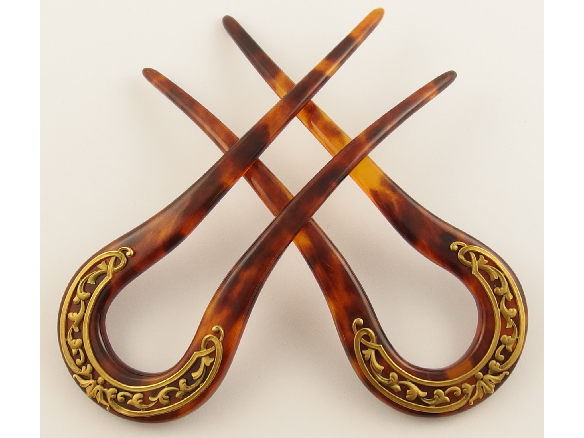 Appraisal: A pair of Art Nouveau hair pinsmounted with yellow metal