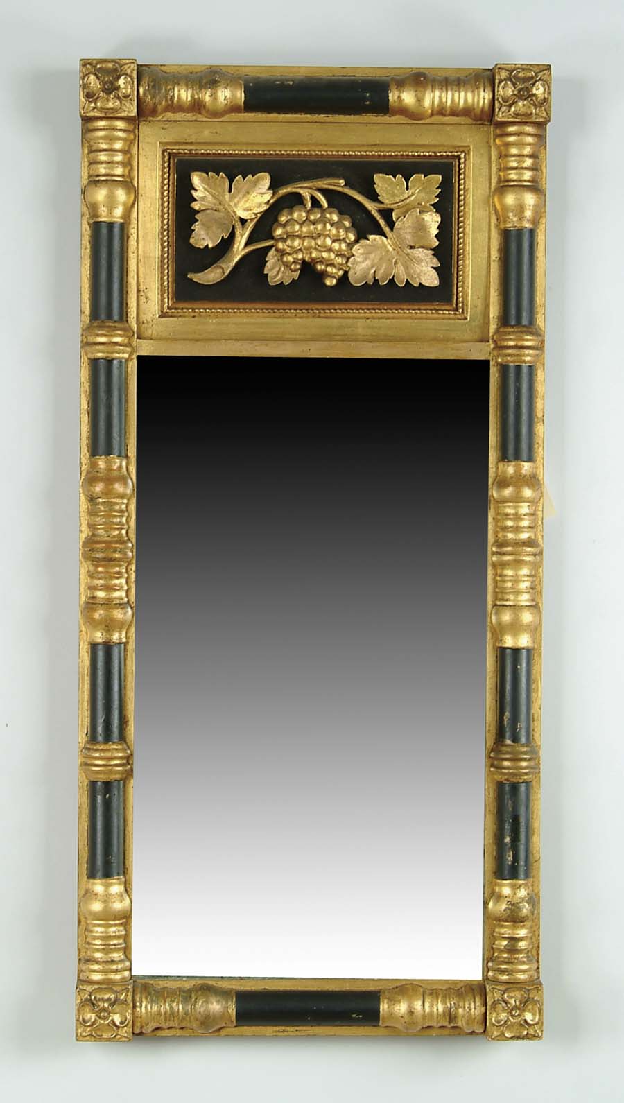 Appraisal: SPLIT COLUMN BLACK AND GOLD GRAPE DECORATED MIRROR Split columns