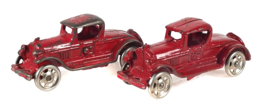 Appraisal: Two red cast iron roadster or coupe toy cars possibly