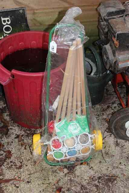 Appraisal: A CHILD'S GARDEN GAMES SET on a yellow wheeled carrier