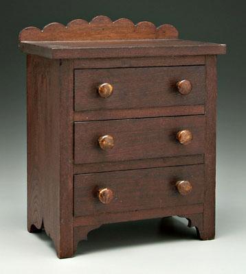 Appraisal: American walnut miniature chest scrolled backsplash three dovetailed drawers with