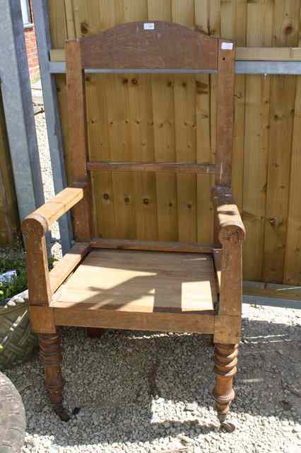 Appraisal: AN OVERSIZED OAK OPEN ARMCHAIR standing on turned front legs