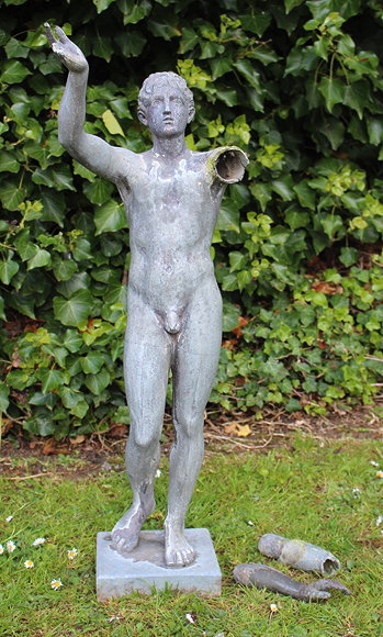 Appraisal: A CAST LEAD SCULPTURE OF A MAN with his arms