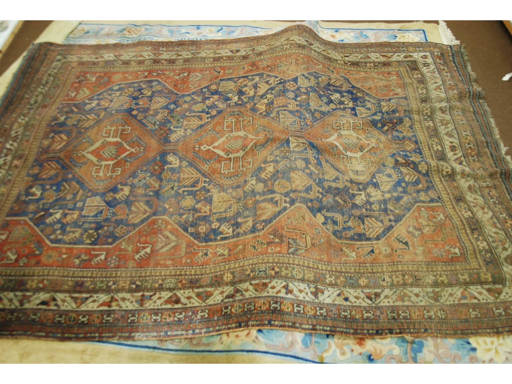 Appraisal: SEMI ANTIQUE SHIRAZ PERSIAN CARPET with red triple pole medallion