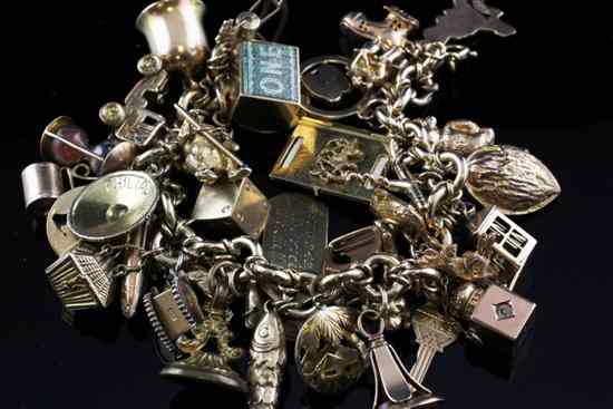 Appraisal: A ct gold circular link charm bracelet hung with forty