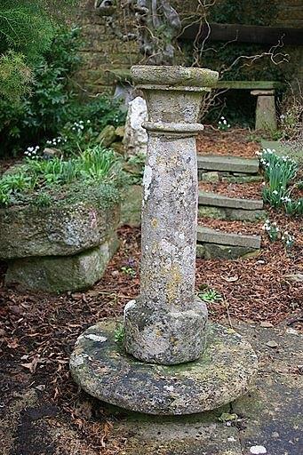 Appraisal: A stone pillar with gun barrel column on a circular