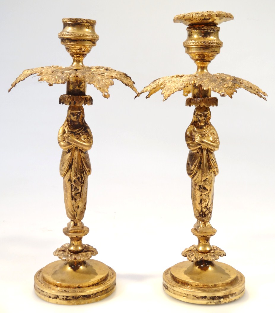 Appraisal: A pair of thC brass candlesticks each with inverted circular