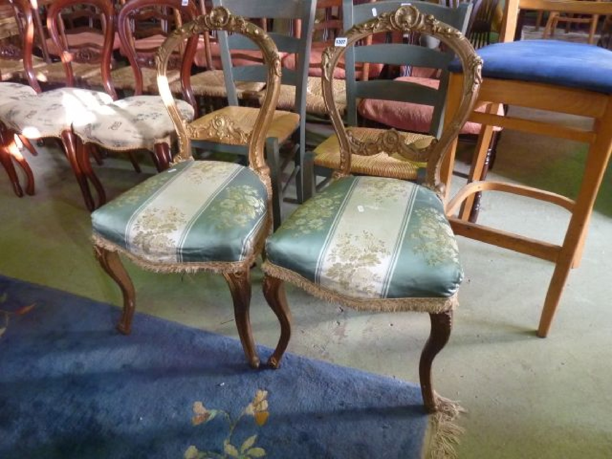 Appraisal: A pair of Victorian balloonback dining chairs with deeply carved