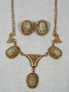 Appraisal: An carat gold necklace and matching earrings set with carved