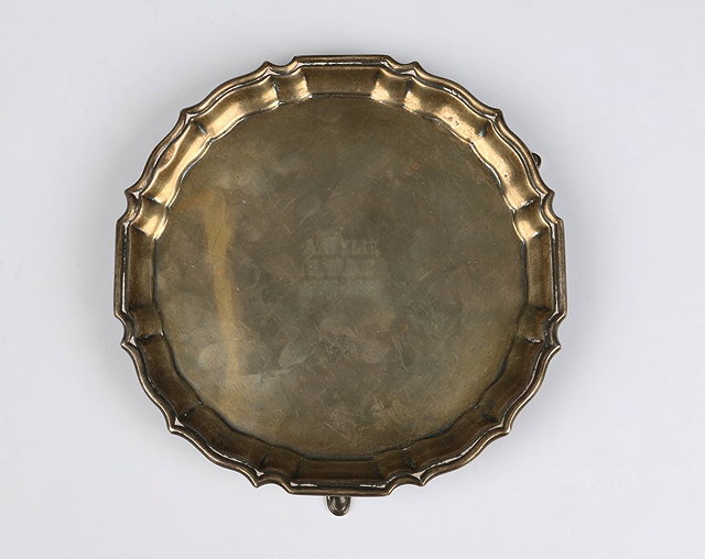 Appraisal: A SILVER WAITER with a Chippendale border three cabriole legs