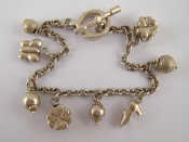 Appraisal: A white metal tests silver charm bracelet approx cm long