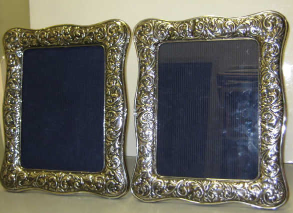 Appraisal: PAIR OF STERLING SILVER FRAMES Shaped rectangular with foliate repousse