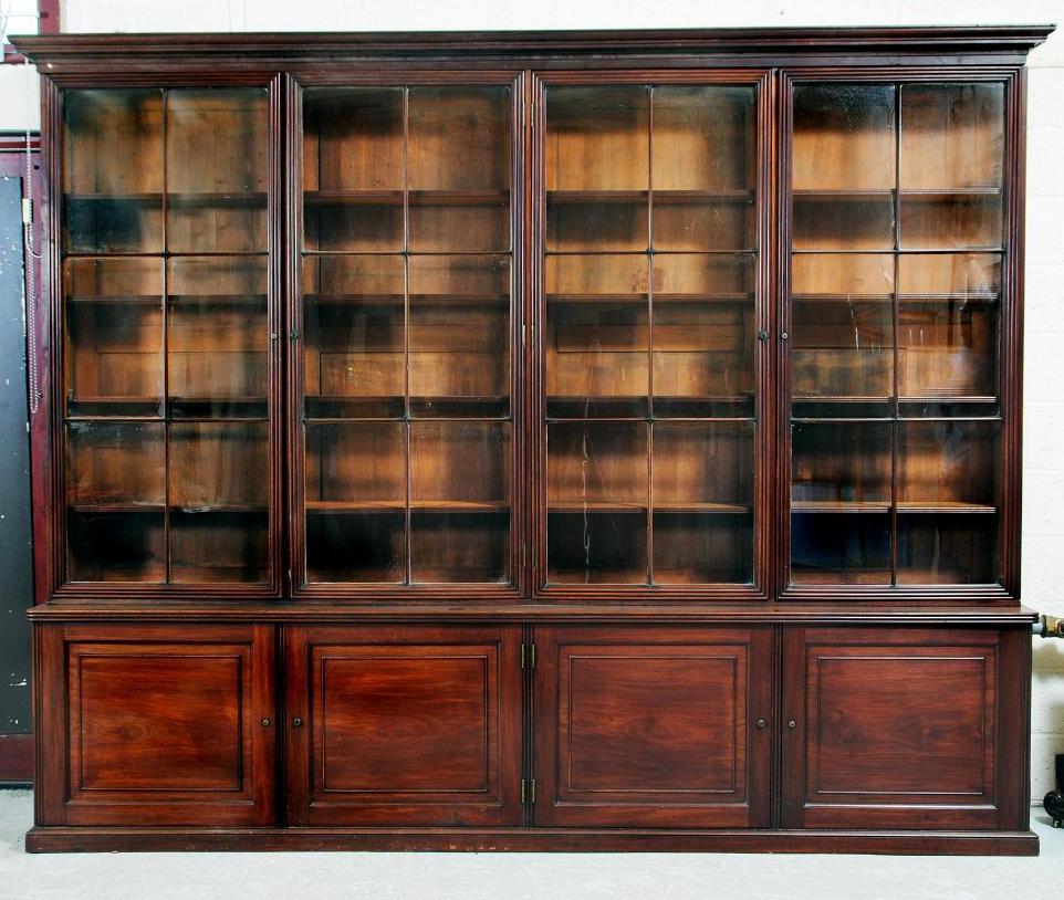 Appraisal: A GEORGIAN MAHOGANY BOOKCASE early th century the cavetto moulded