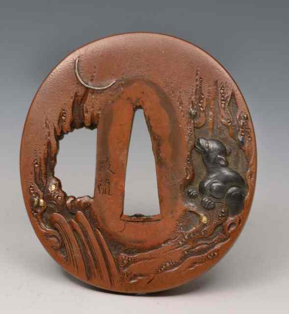 Appraisal: A JAPANESE TSUBA of patenated and chased copper with signature