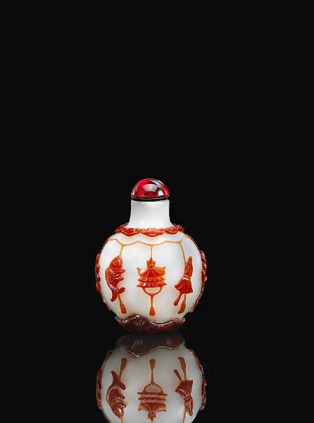 Appraisal: A red overlay milky white glass bottle Of compressed ovoid