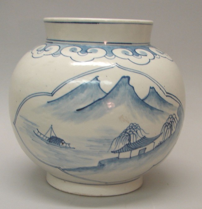 Appraisal: Blue and white vase features landscape and seascape motifs in